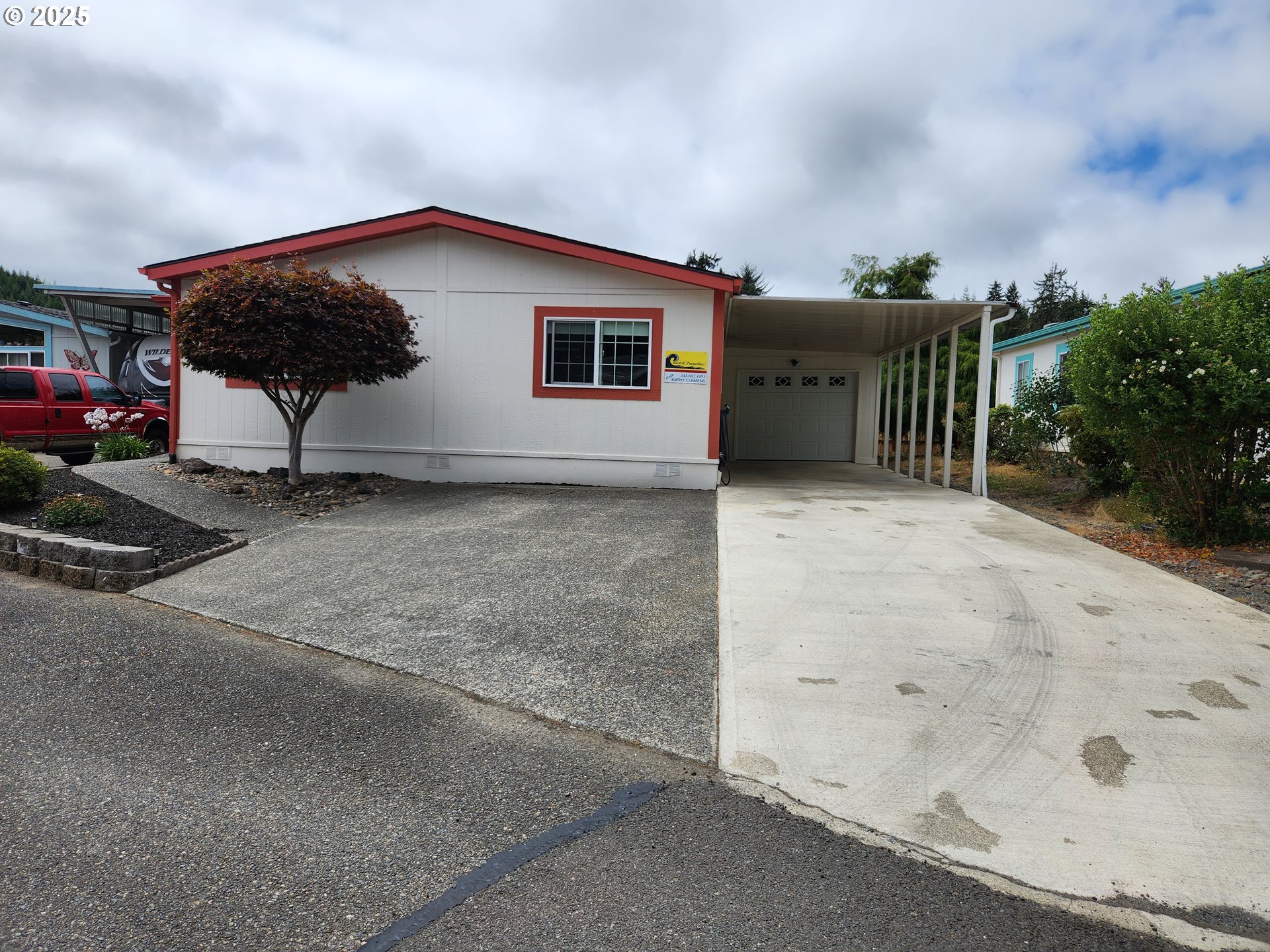 100 River Bend Road, Unit 103 Reedsport, OR 97467 - Photo 1 of 26 a backyard of a house with table and chairs