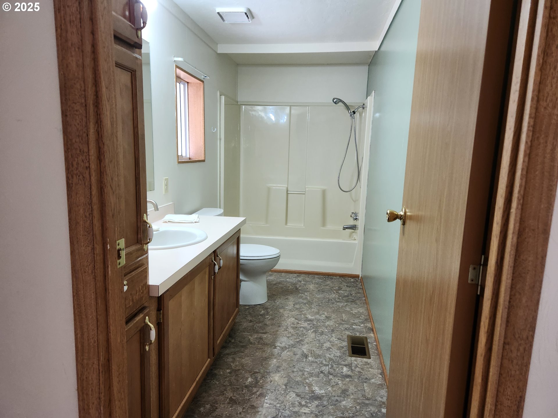 100 River Bend Road, Unit 103 Reedsport, OR 97467 - Photo 25 of 26 a bathroom with a granite countertop sink a toilet and shower