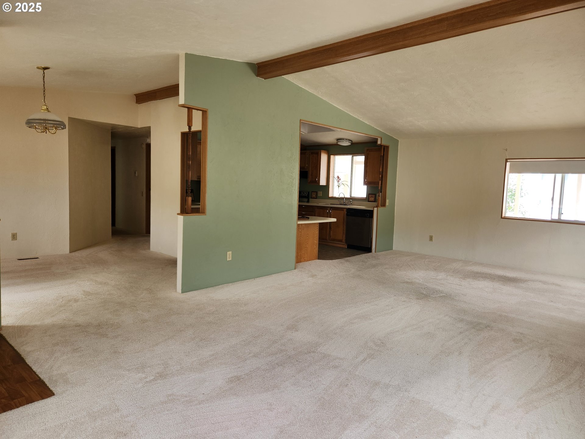 100 River Bend Road, Unit 103 Reedsport, OR 97467 - Photo 9 of 26 an empty room with windows and cabinet