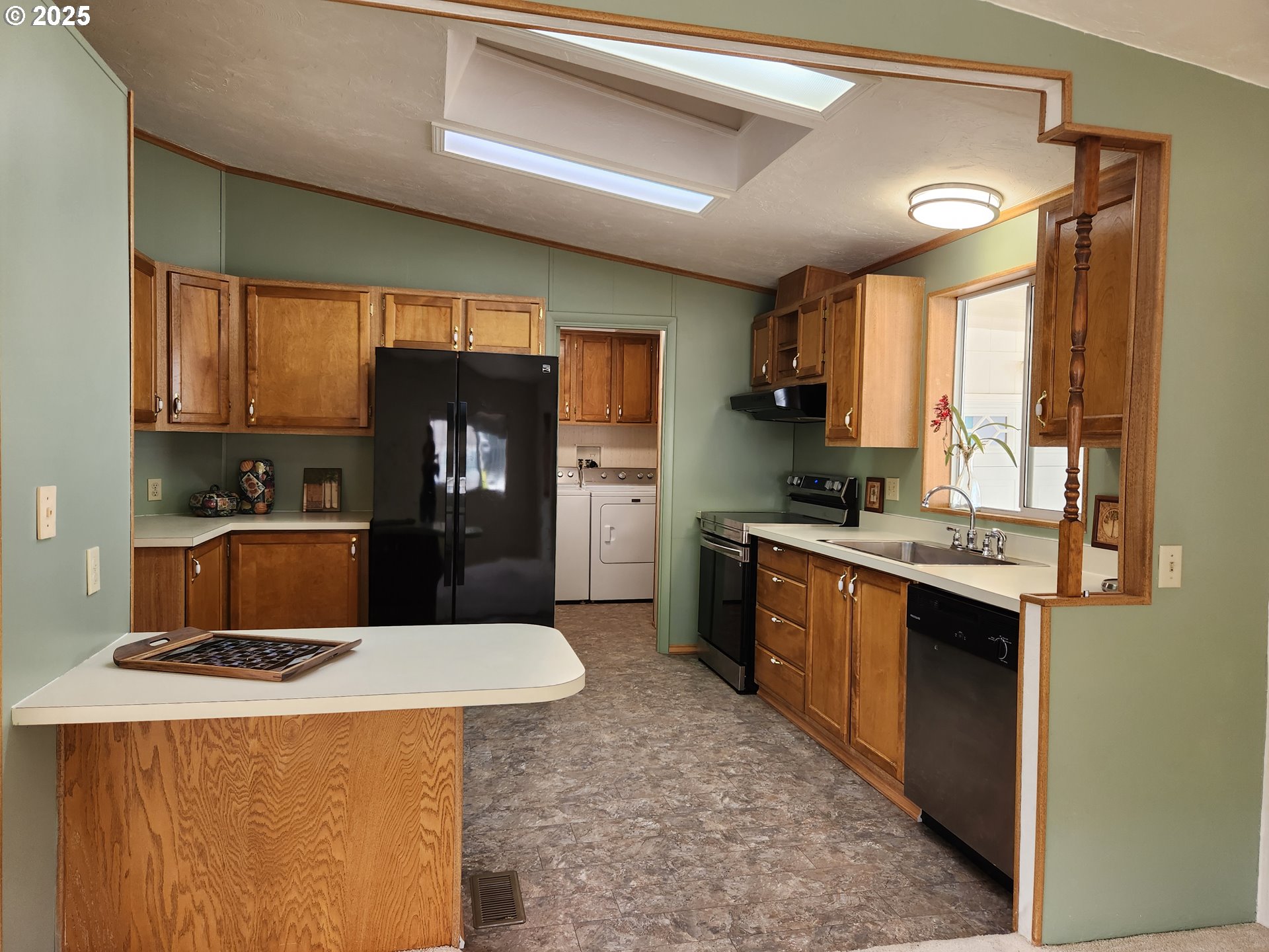100 River Bend Road, Unit 103 Reedsport, OR 97467 - Photo 10 of 26 a kitchen with a stove a sink and a refrigerator
