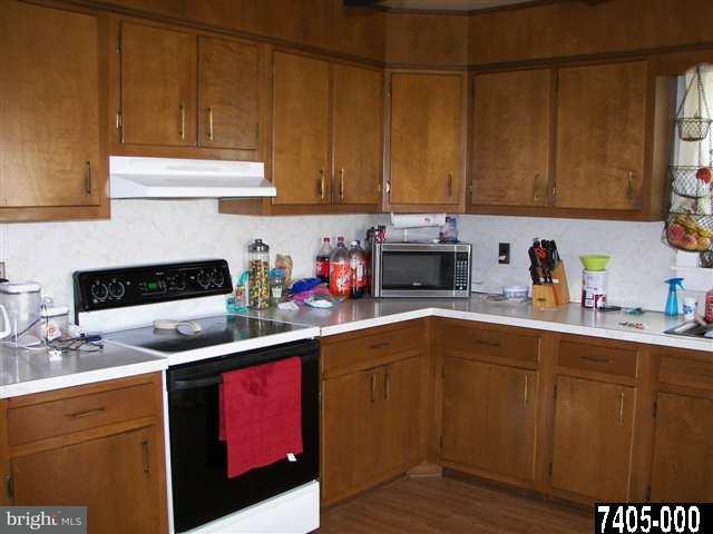 21 South Biesecker Road York, PA 17408 - Photo 10 of 18 a kitchen with stainless steel appliances granite countertop a sink dishwasher stove and cabinets with wooden floor