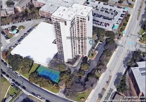 an aerial view of a residential apartment building with a yard