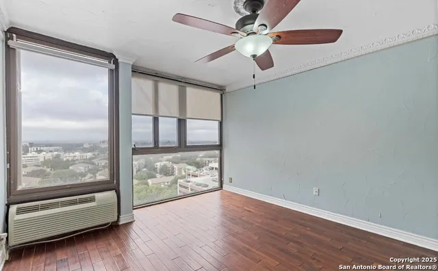 an empty room with wooden floor and door