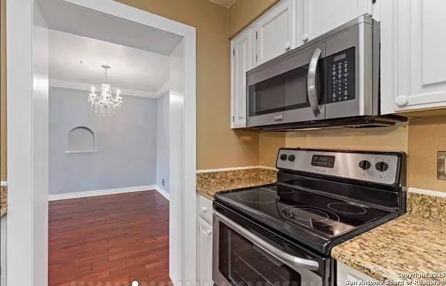 a stove top oven sitting inside of a kitchen