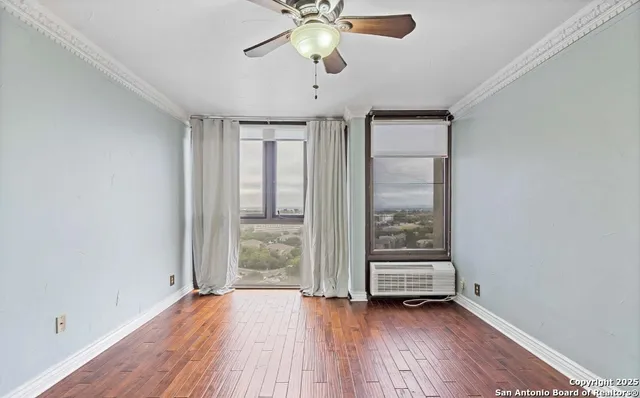 wooden floor in an empty room with a window