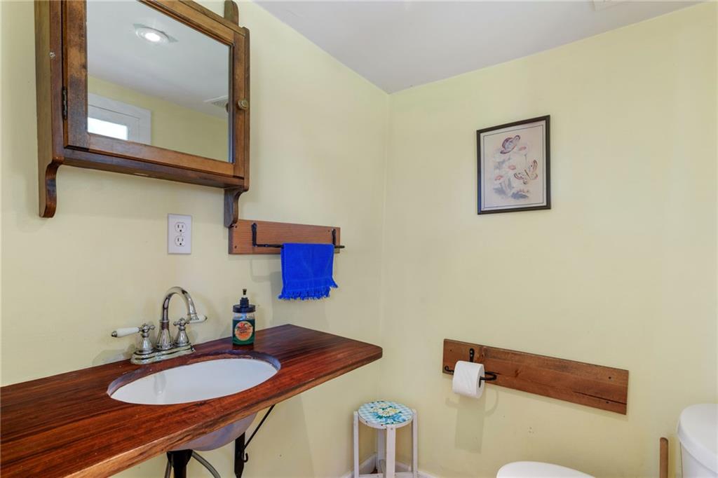 777 Main Street Addison, PA 15411 - Photo 15 of 35 a bathroom with a sink mirror and toilet