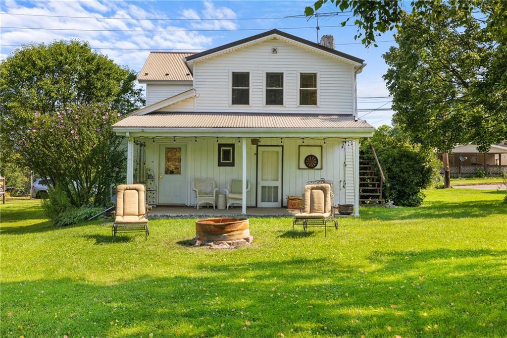 777 Main Street Addison, PA 15411 - Photo 26 of 35 a front view of a house with a yard patio and fire pit