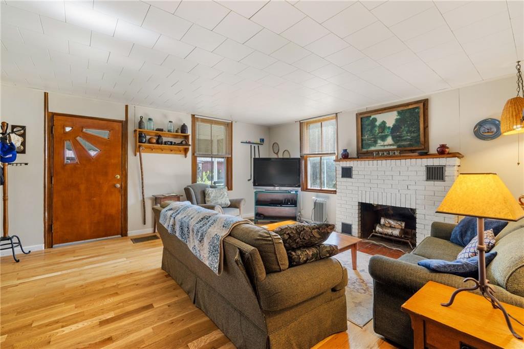 777 Main Street Addison, PA 15411 - Photo 5 of 35 a living room with furniture and a fireplace
