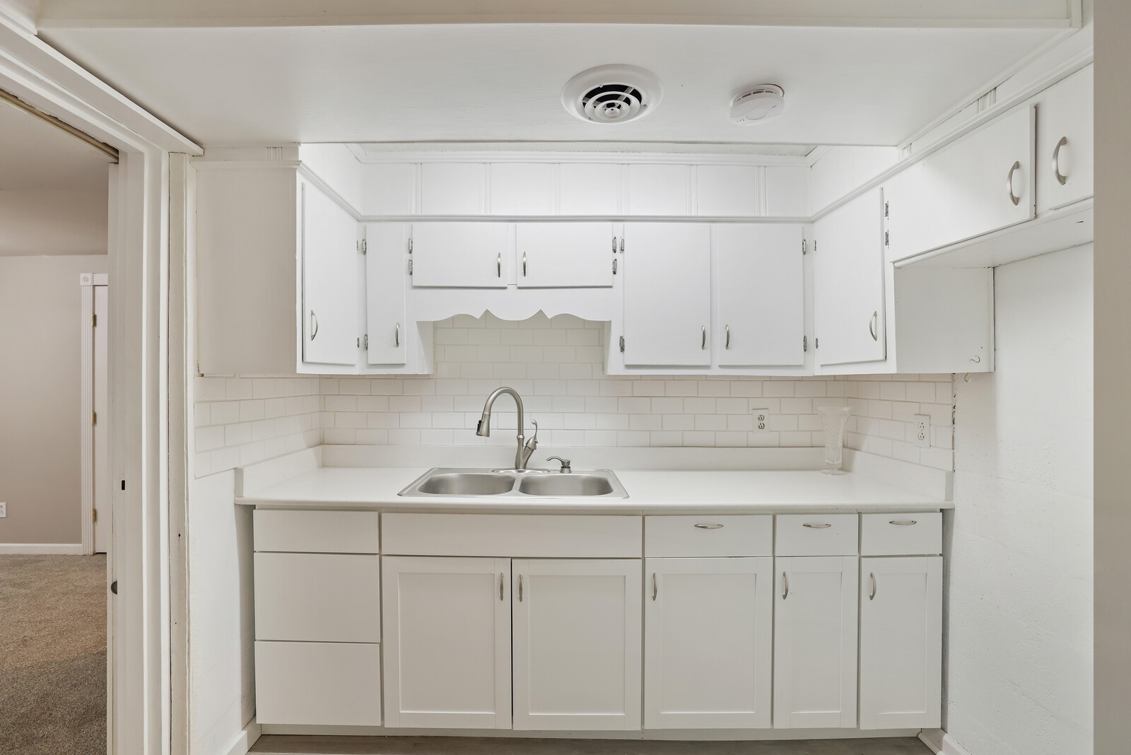 676 Ferguson Hill Road Lafayette, TN 37083 - Photo 50 of 89 a kitchen with white cabinets and white appliances