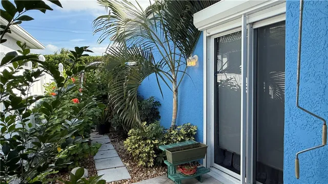 a view of a flower garden in front of a house