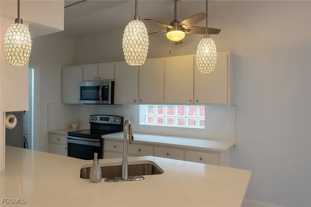 a kitchen with stainless steel appliances a microwave a stove and a refrigerator