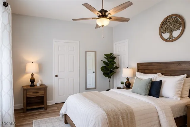 a bedroom with bed and a chandelier