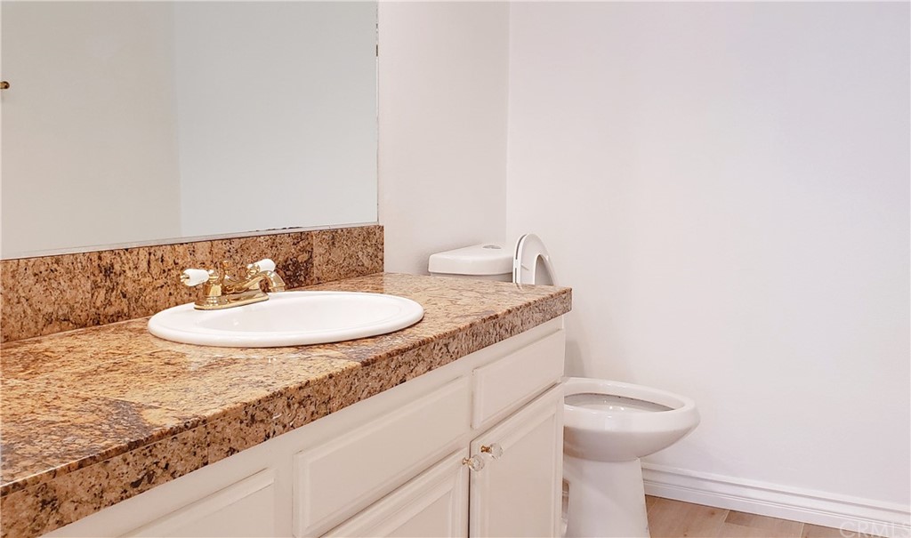33 Valley, Unit 35 Irvine, CA 92612 - Photo 11 of 31 a bathroom with a granite countertop sink and a mirror