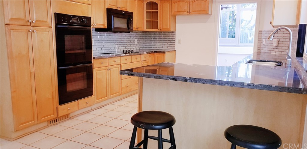 33 Valley, Unit 35 Irvine, CA 92612 - Photo 13 of 31 a bathroom with a granite countertop sink and a toilet