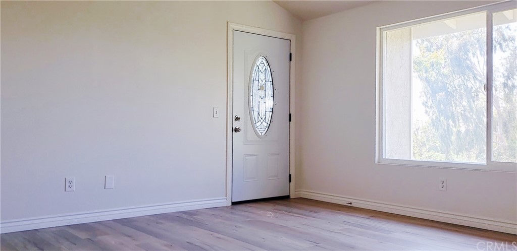 33 Valley, Unit 35 Irvine, CA 92612 - Photo 15 of 31 an empty room with wooden floor and a window