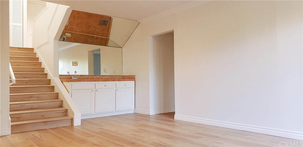 33 Valley, Unit 35 Irvine, CA 92612 - Photo 22 of 31 a view of a hallway with wooden floor and entryway