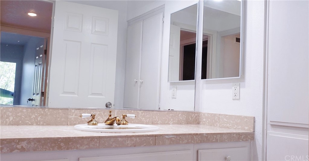 33 Valley, Unit 35 Irvine, CA 92612 - Photo 27 of 31 a bathroom with a granite countertop sink and a mirror