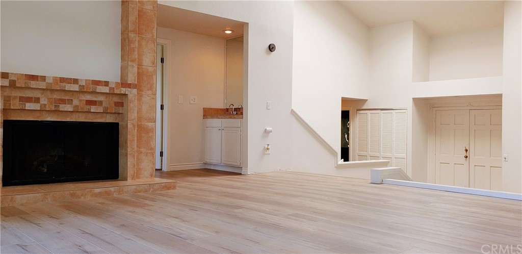 33 Valley, Unit 35 Irvine, CA 92612 - Photo 9 of 31 a view of empty room with wooden floor and fireplace