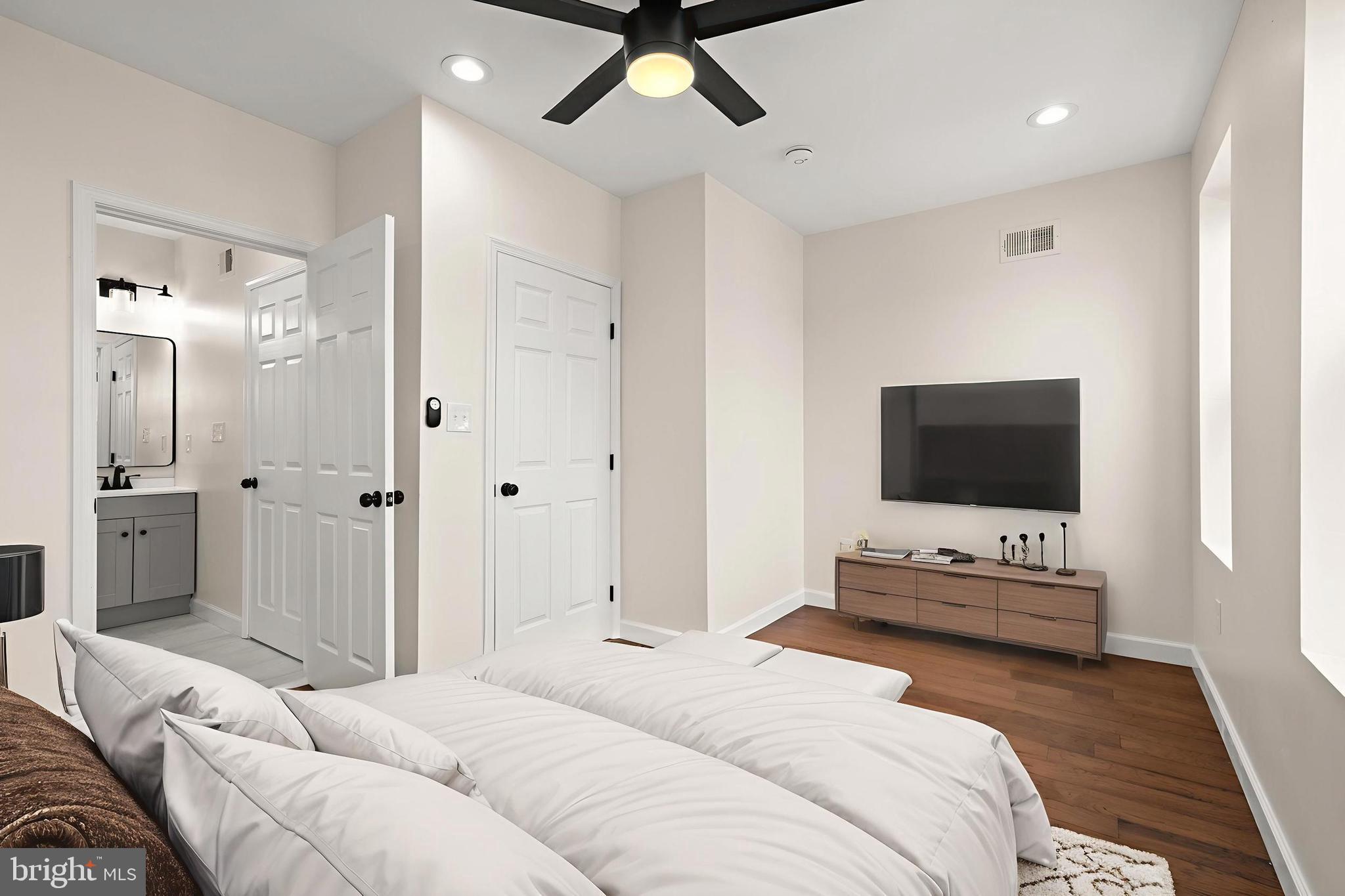 2815 West Cold Spring Lane Baltimore, MD 21215 - Photo 11 of 37 a bedroom with a bed and a flat screen tv