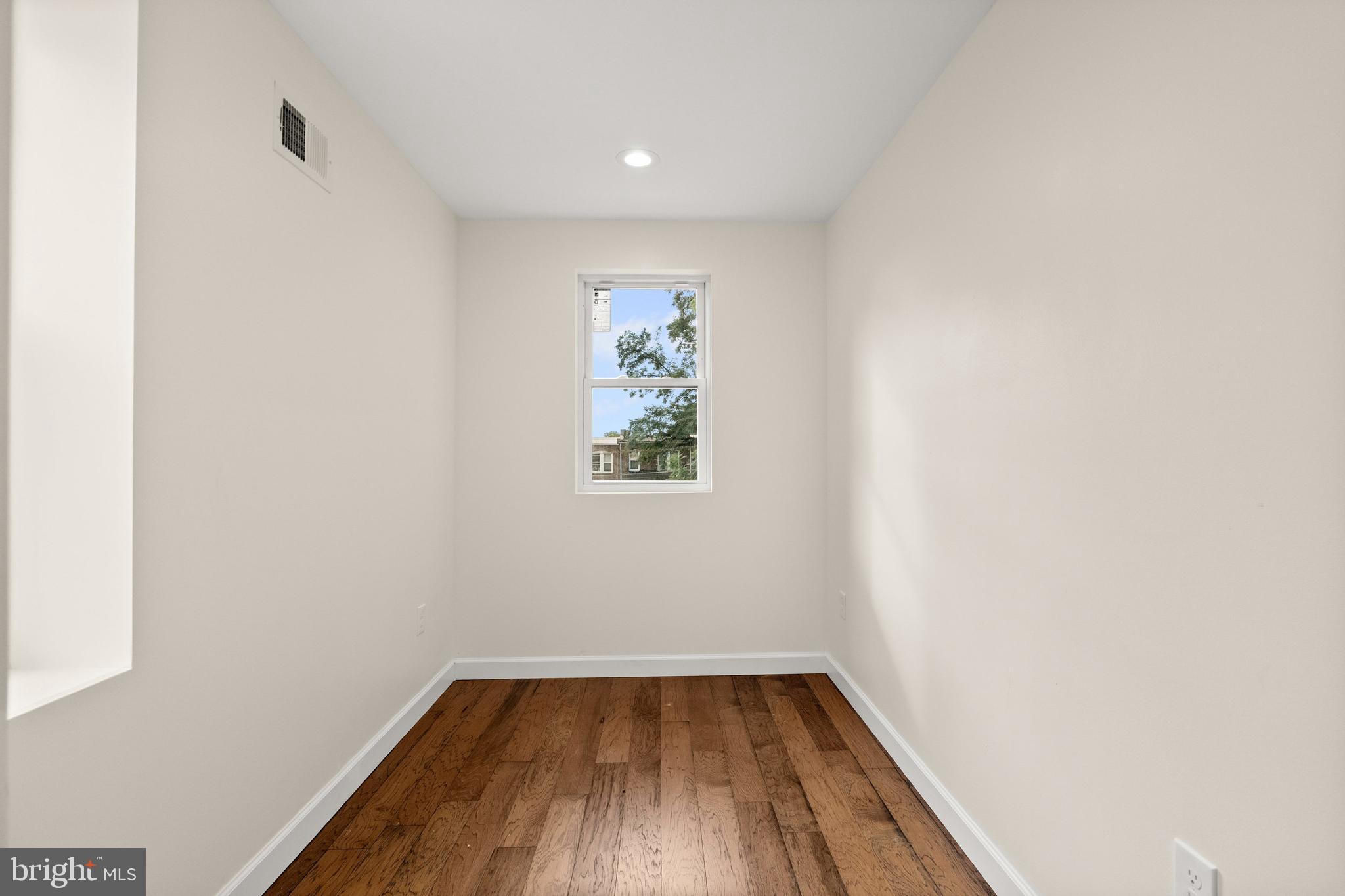 2815 West Cold Spring Lane Baltimore, MD 21215 - Photo 17 of 37 a view of a room with wooden floor and window