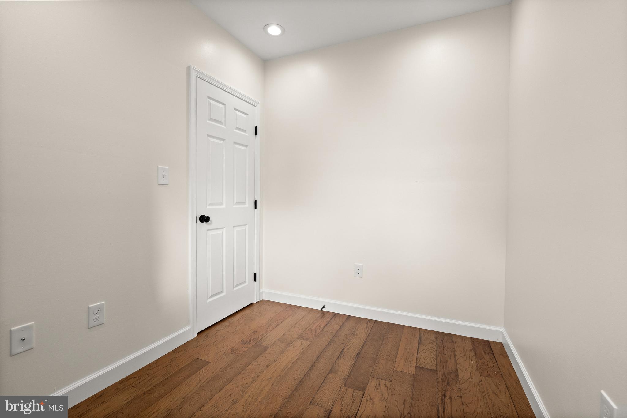 2815 West Cold Spring Lane Baltimore, MD 21215 - Photo 19 of 37 a view of an empty room with wooden floor