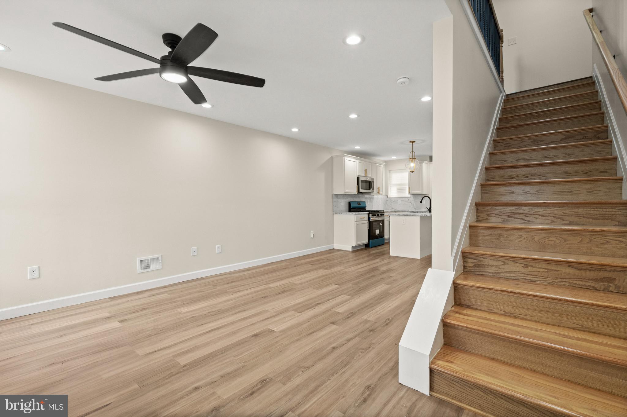 2815 West Cold Spring Lane Baltimore, MD 21215 - Photo 4 of 37 wooden floor in an empty room with wooden floor and a ceiling fan