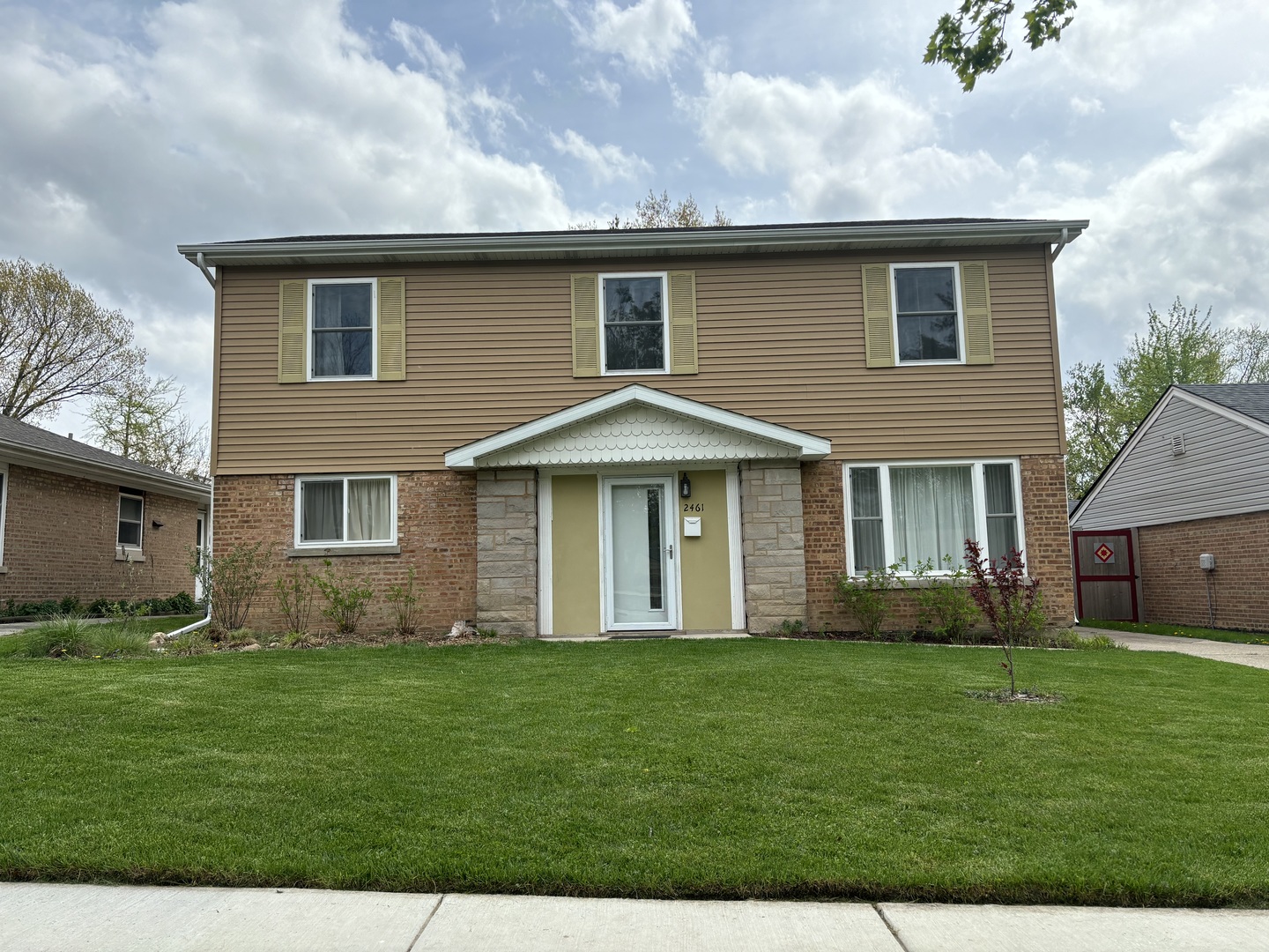 2461 Hawthorne Road Homewood, IL 60430 - Photo 1 of 37 a front view of a house with a garden and yard