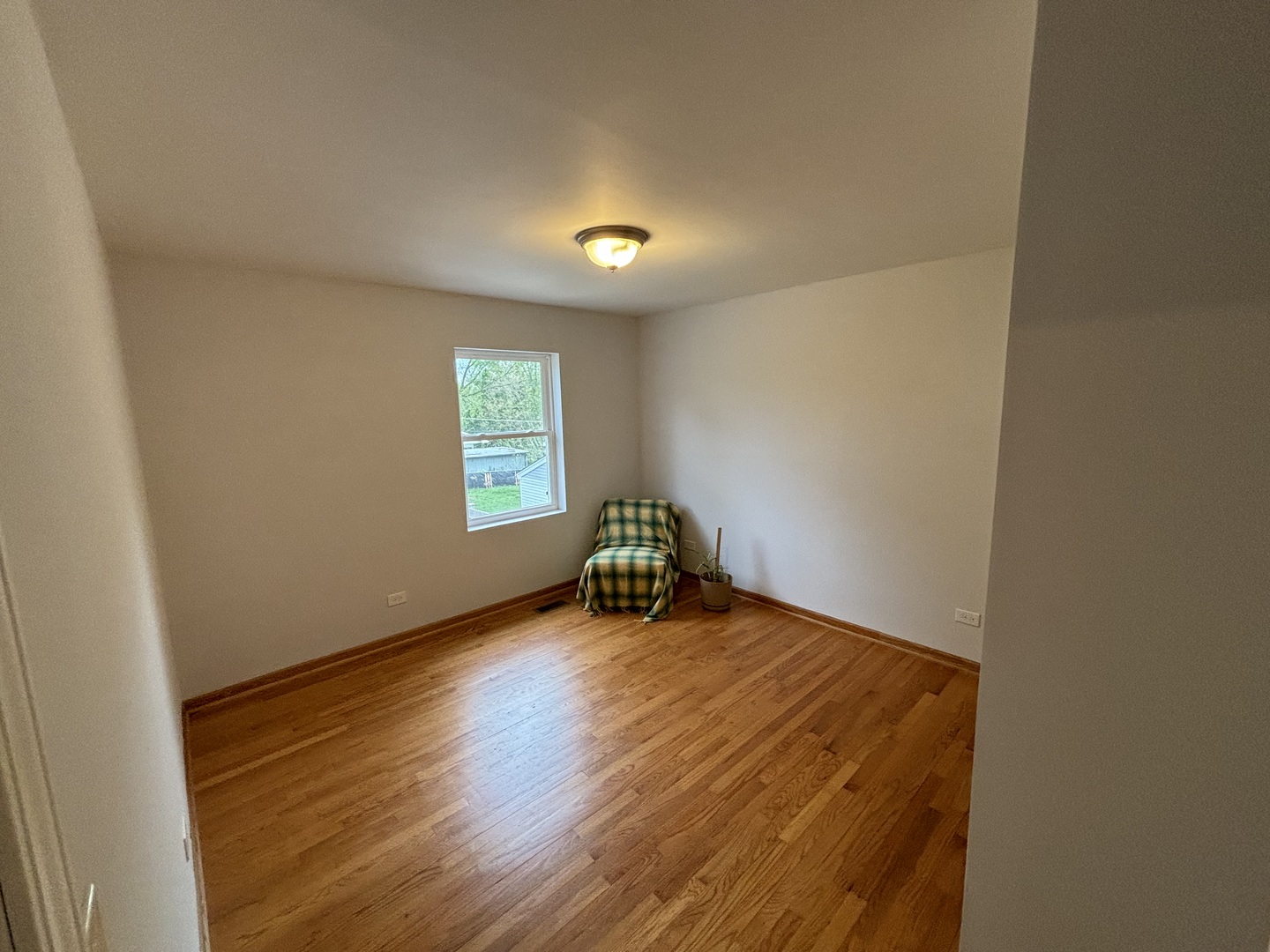2461 Hawthorne Road Homewood, IL 60430 - Photo 19 of 37 a view of an empty room with wooden floor and a window
