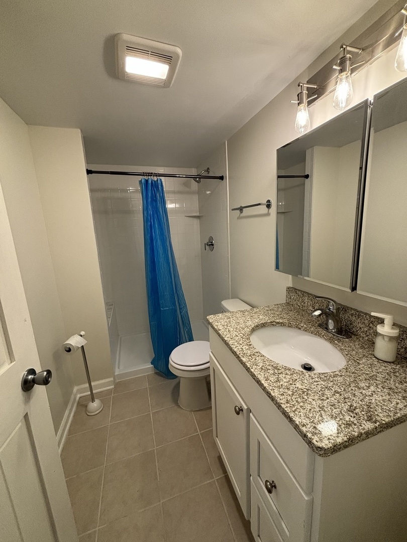 2461 Hawthorne Road Homewood, IL 60430 - Photo 28 of 37 a bathroom with a granite countertop sink toilet and shower