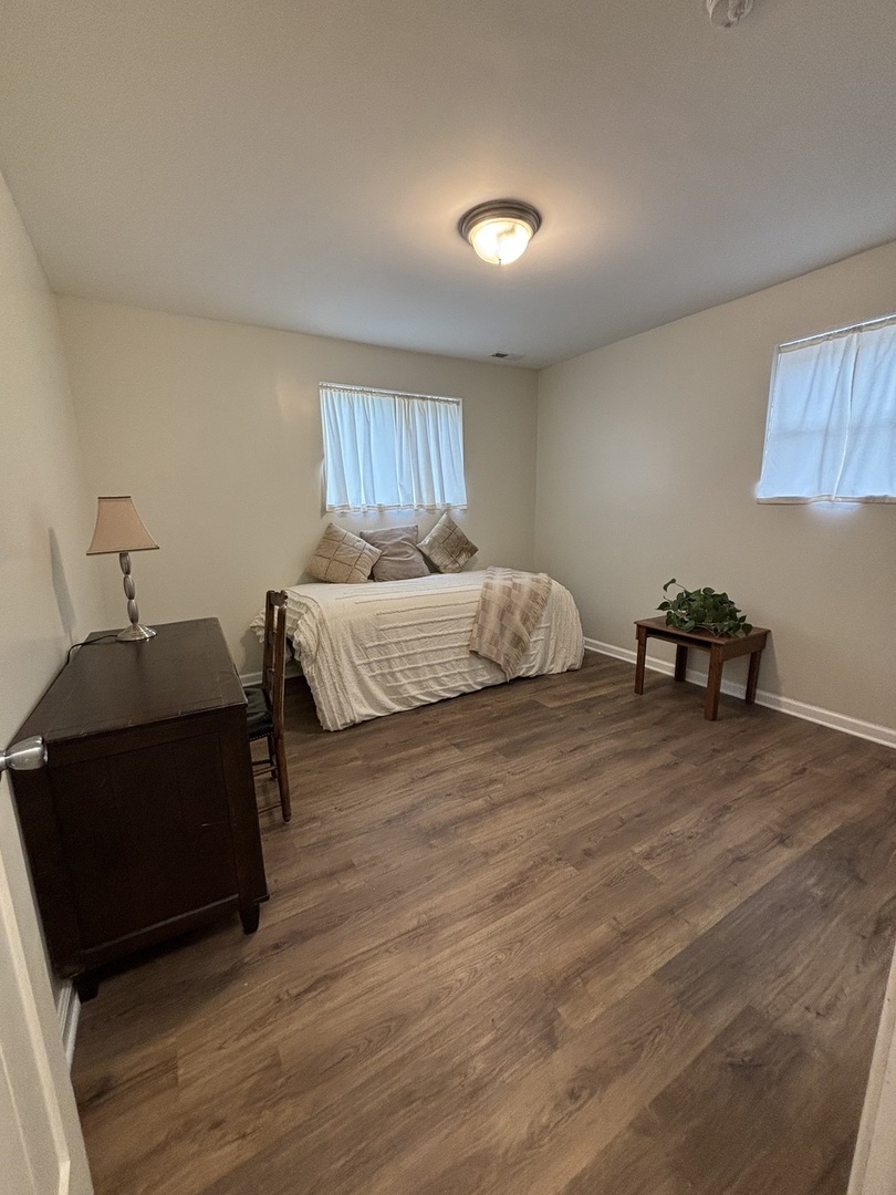 2461 Hawthorne Road Homewood, IL 60430 - Photo 30 of 37 a spacious bedroom with a bed and a lamp on dresser