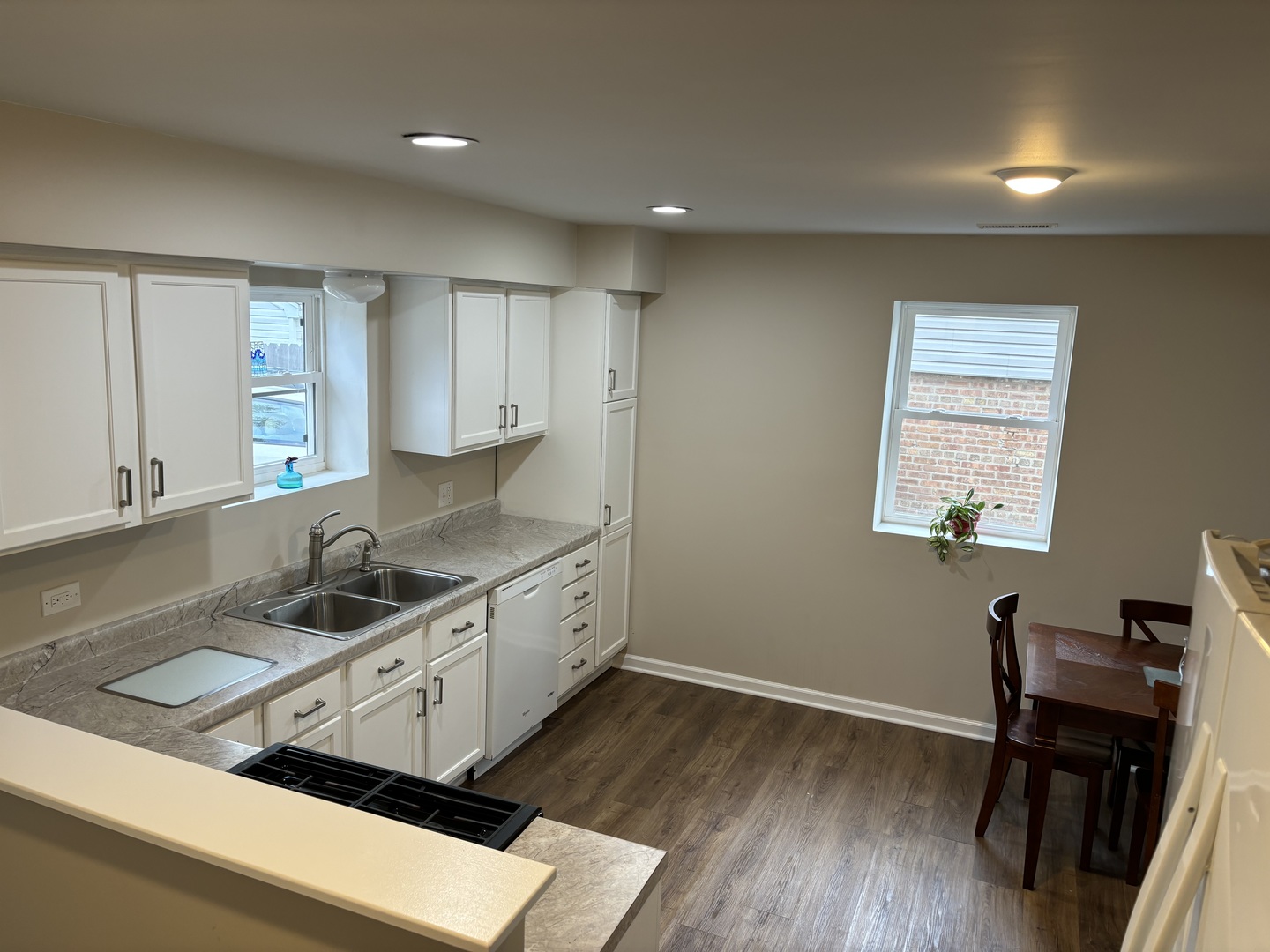 2461 Hawthorne Road Homewood, IL 60430 - Photo 6 of 37 a kitchen that has a sink a chair and wooden cabinets