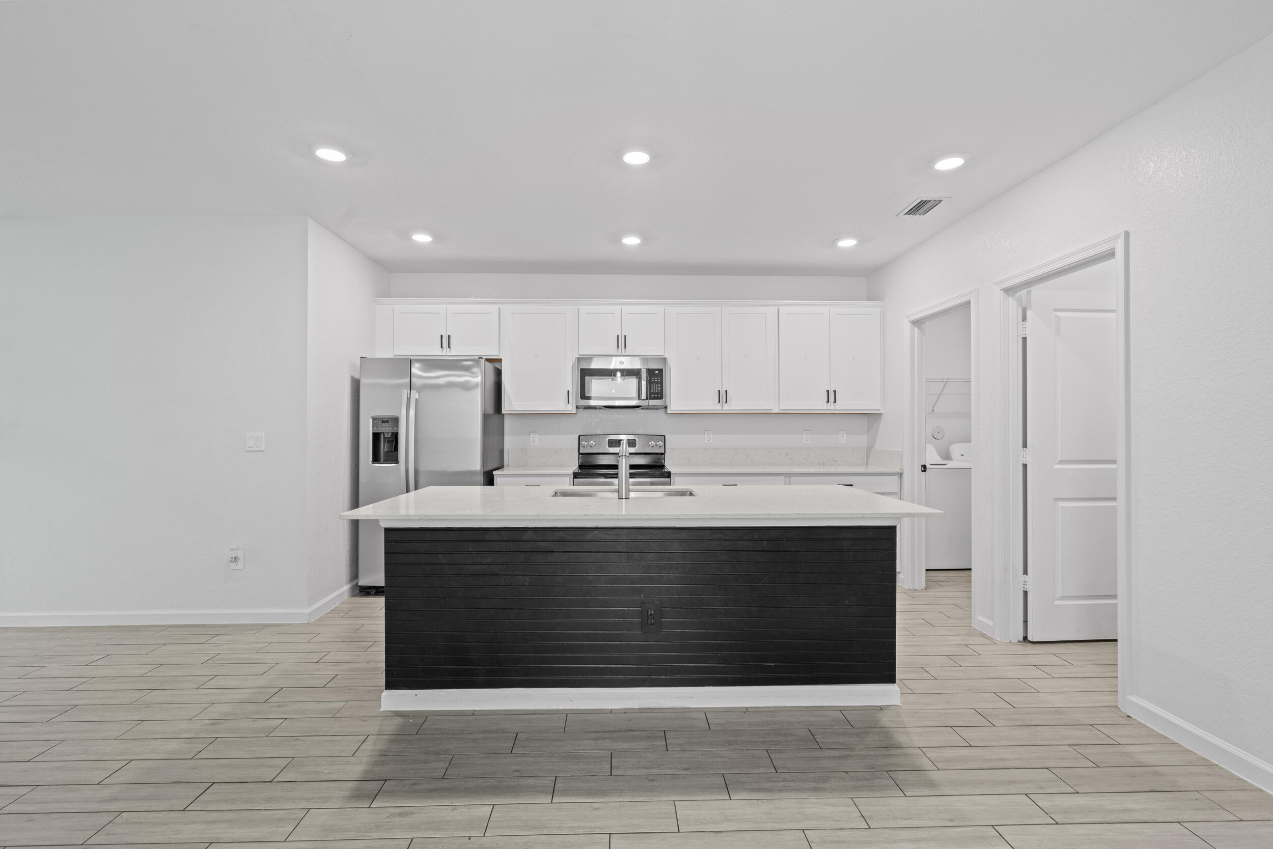 738 Worlington Lane Fort Pierce, FL 34947 - Photo 11 of 69 a view of kitchen with stainless steel appliances granite countertop a sink and cabinets