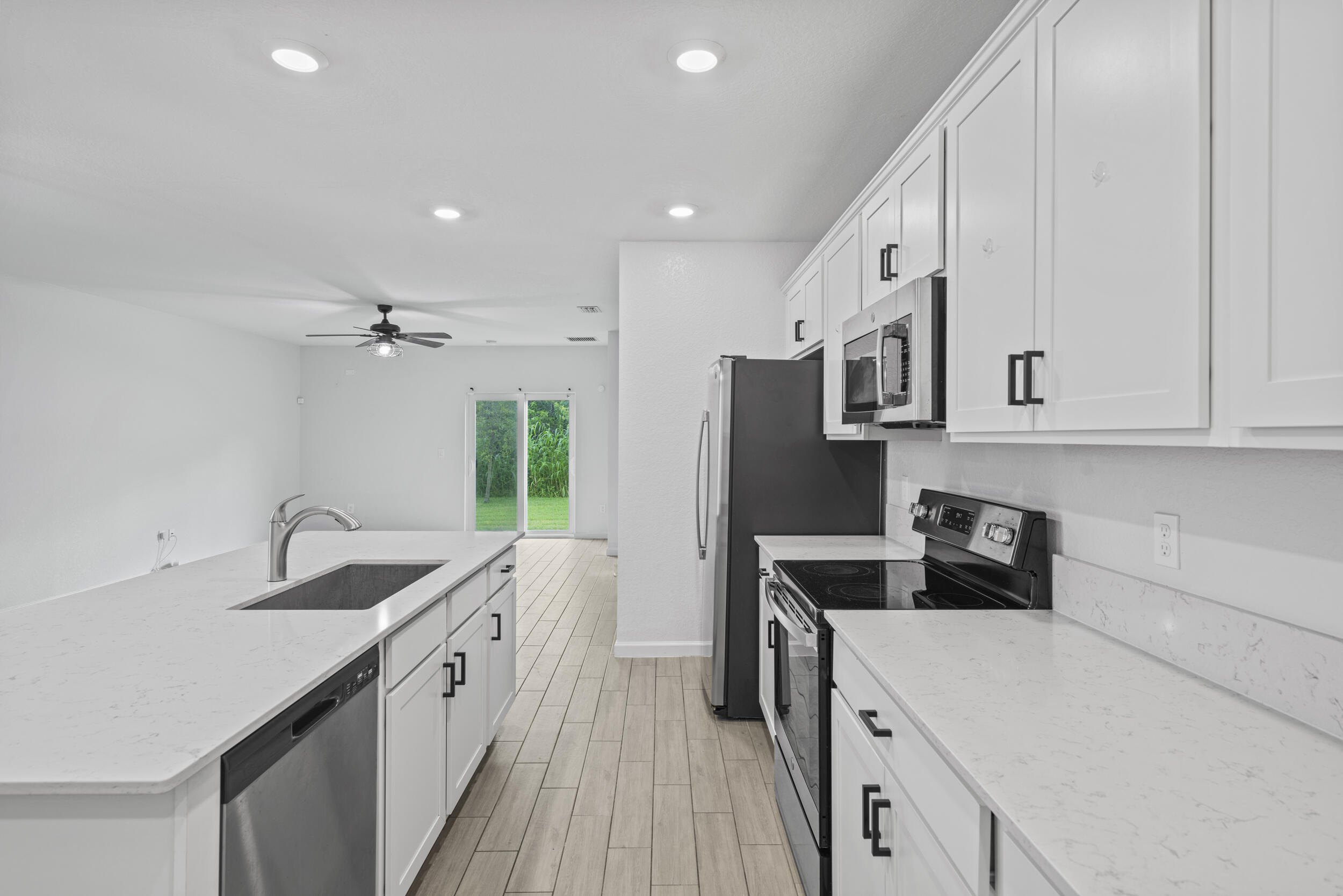 738 Worlington Lane Fort Pierce, FL 34947 - Photo 12 of 69 a kitchen with a sink stove and refrigerator