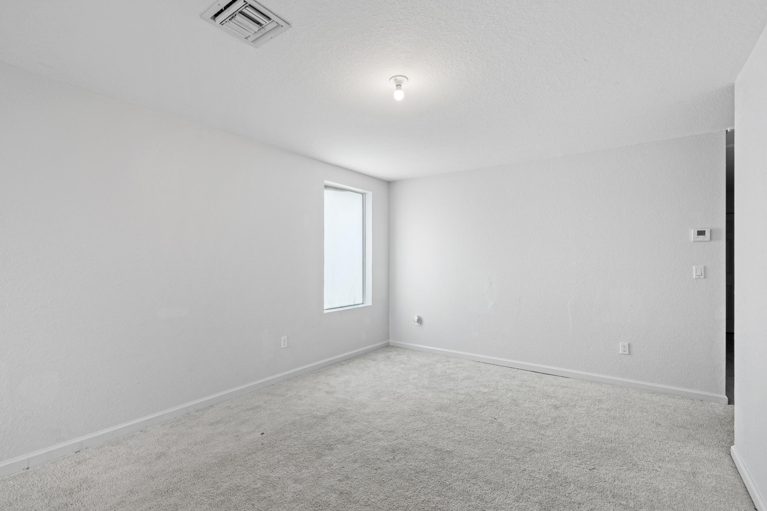 738 Worlington Lane Fort Pierce, FL 34947 - Photo 31 of 69 an empty room with a empty space and windows