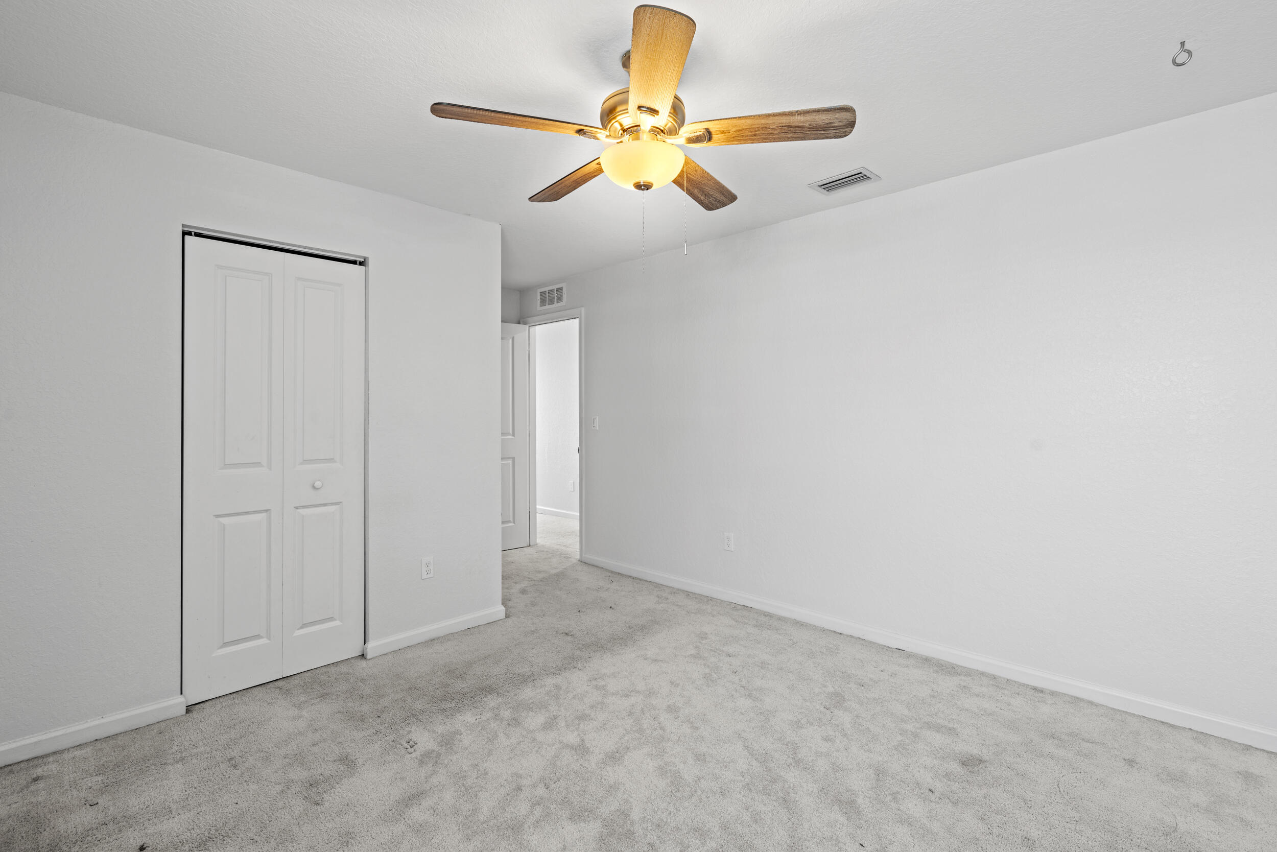 738 Worlington Lane Fort Pierce, FL 34947 - Photo 36 of 69 an empty room with closet and fan