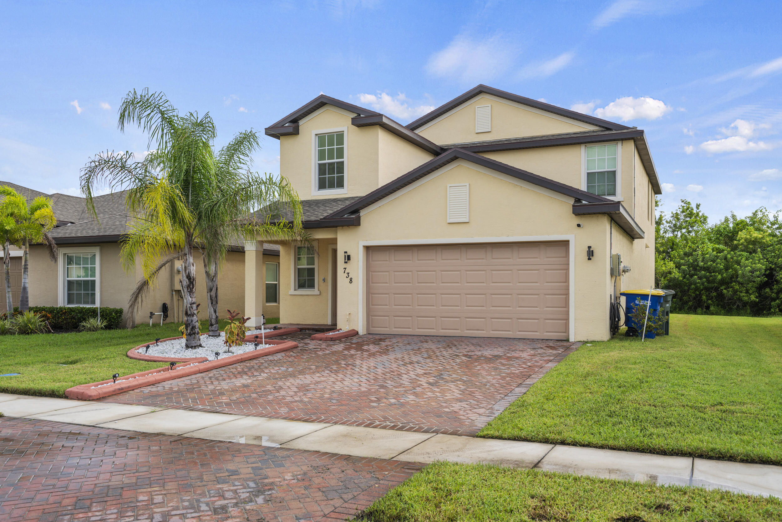 738 Worlington Lane Fort Pierce, FL 34947 - Photo 60 of 69 a front view of a house with a yard and garage