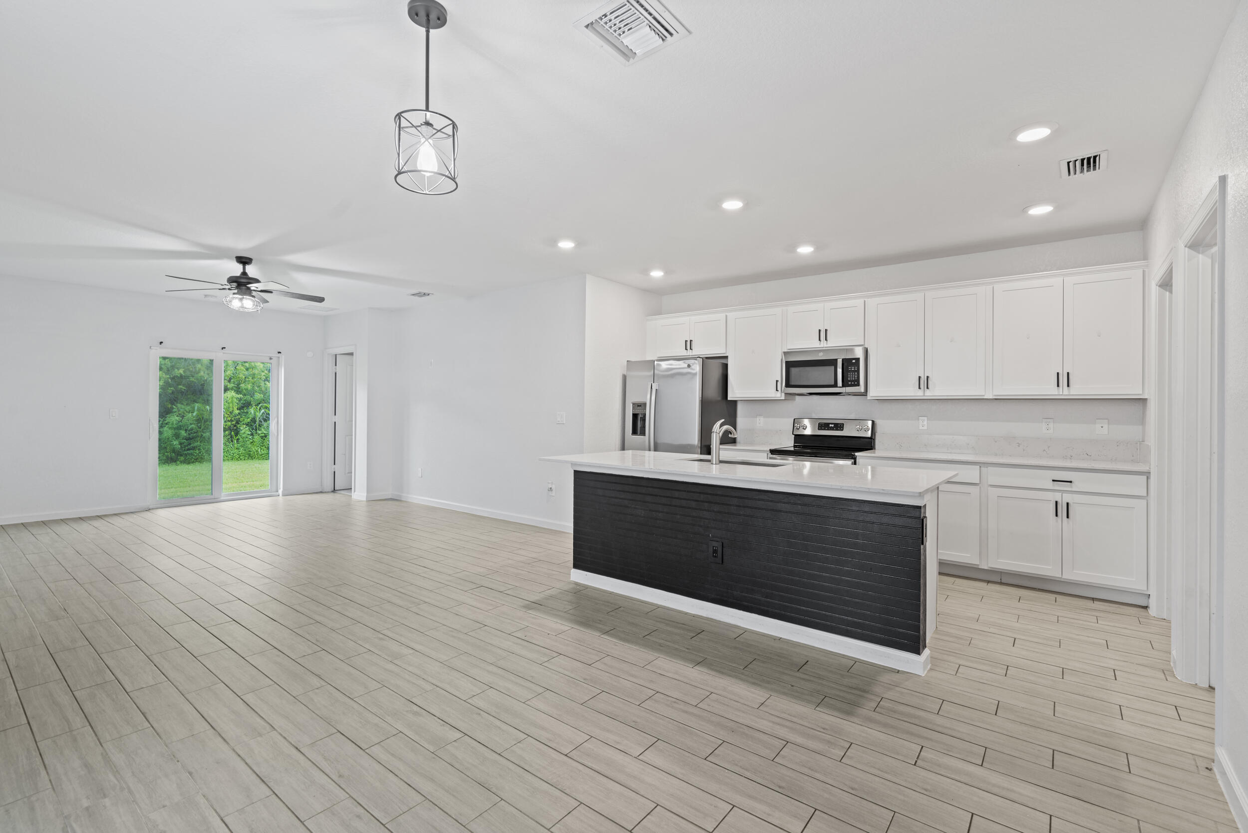 738 Worlington Lane Fort Pierce, FL 34947 - Photo 8 of 69 a large kitchen with stainless steel appliances granite countertop a large counter top a sink and a stove