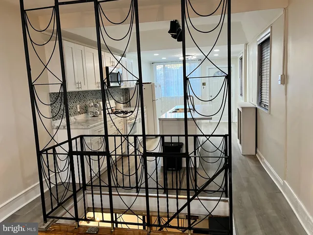 a kitchen with white cabinets sink and stainless steel appliances