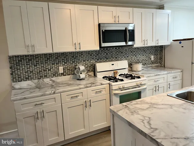 a room with a bed and a refrigerator