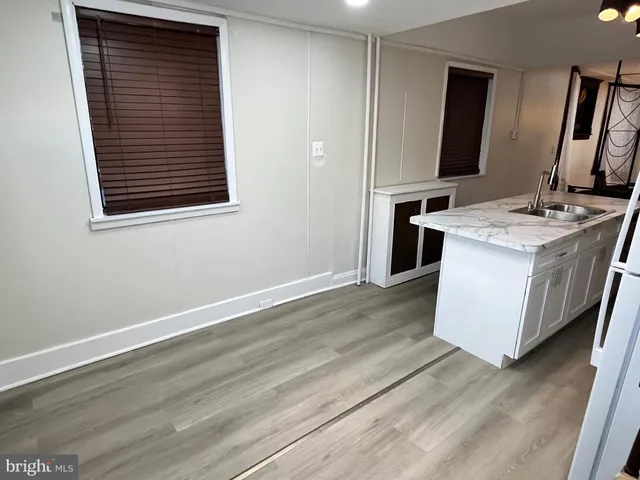 a kitchen with stainless steel appliances granite countertop a sink stove microwave and refrigerator