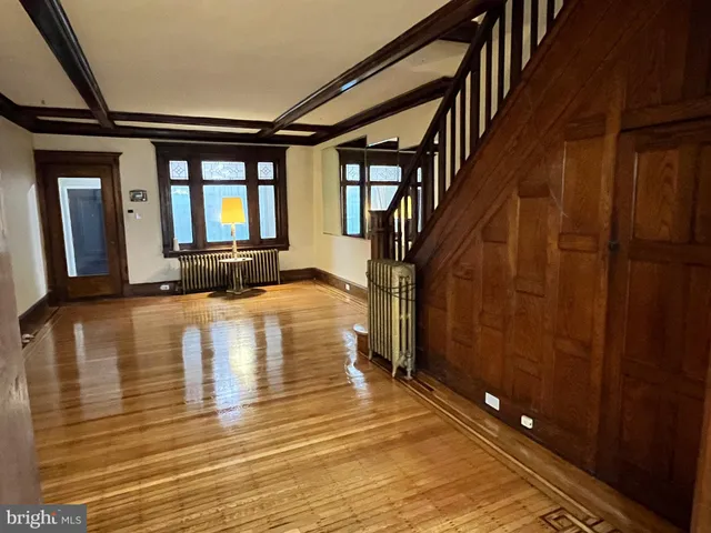 a view of a room with wooden floor and a window