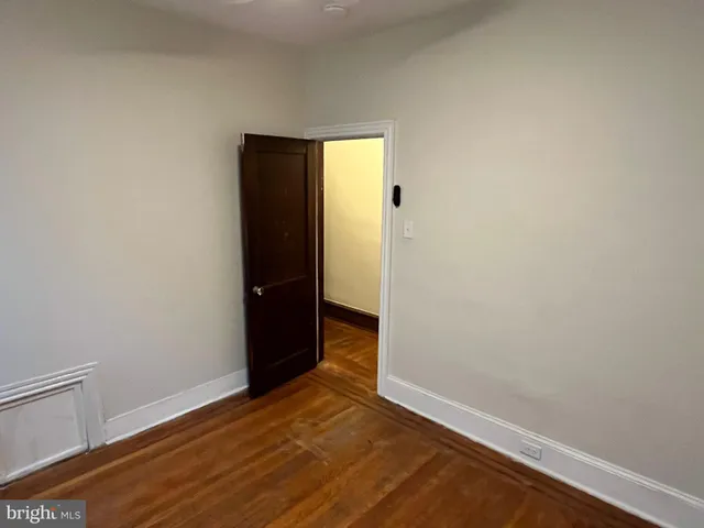 a view of hallway with wooden floor