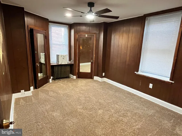 a view of a hallway with wooden floor and entryway