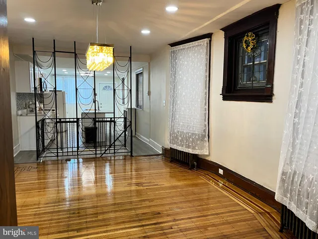 a view of a living room with a wooden floor and a fireplace