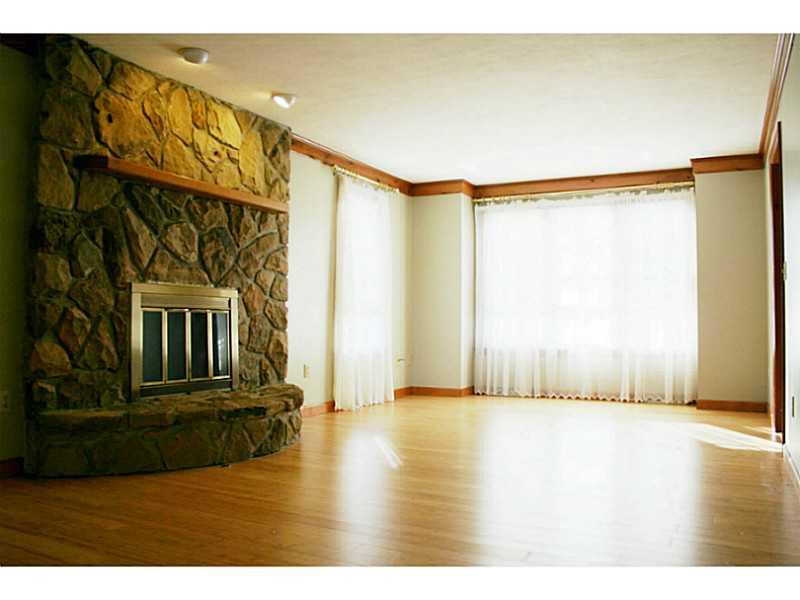 Family Room. BEAUTIFUL BAMBOO FLOORING AND STONE FIREPLACE WILL WARM YOU THROUGH THE WINTER MONTHS.