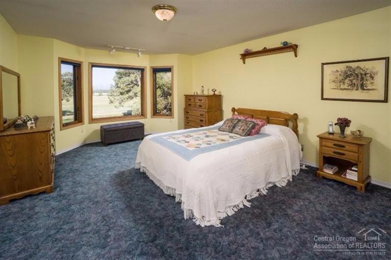 22183 Erickson Road Bend, OR 97701 - Photo 21 of 25 Master bedroom with views of the mountai