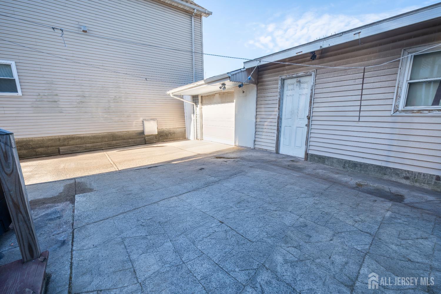 269 Silzer Street Perth Amboy, NJ 08861 - Photo 3 of 13 a view of a house with a yard and garage