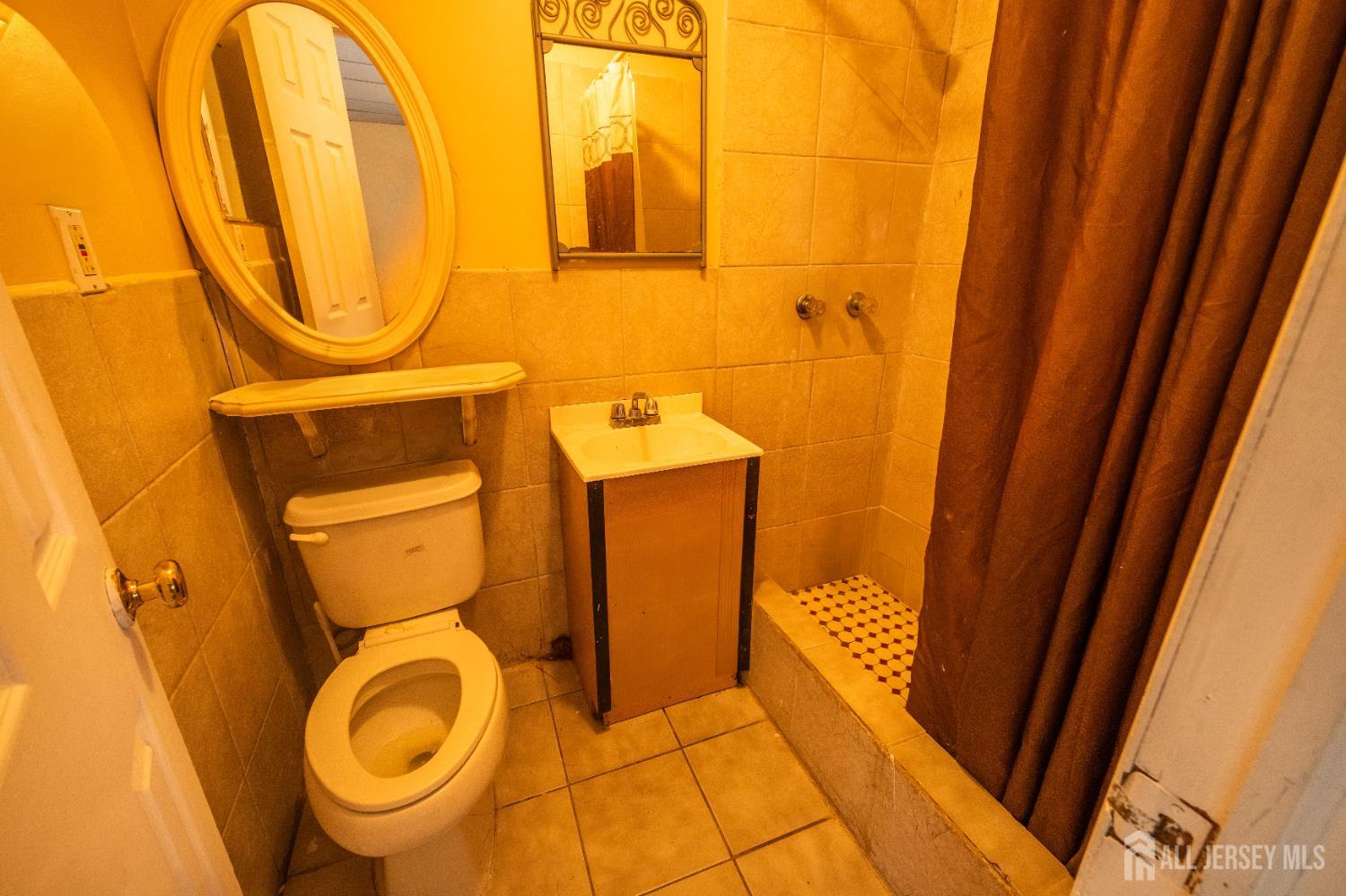 269 Silzer Street Perth Amboy, NJ 08861 - Photo 6 of 13 a bathroom with a sink and a mirror