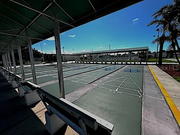 a view of a balcony with furniture and a potted plant
