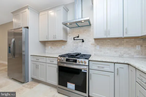 a view of a hallway with bathroom and a sink
